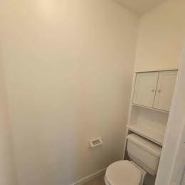 bathroom featuring baseboards and toilet