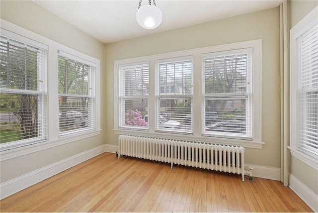 unfurnished sunroom featuring radiator