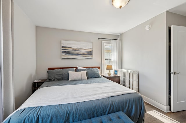 bedroom with radiator and baseboards