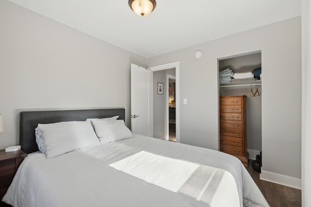 bedroom featuring a closet, baseboards, and wood finished floors