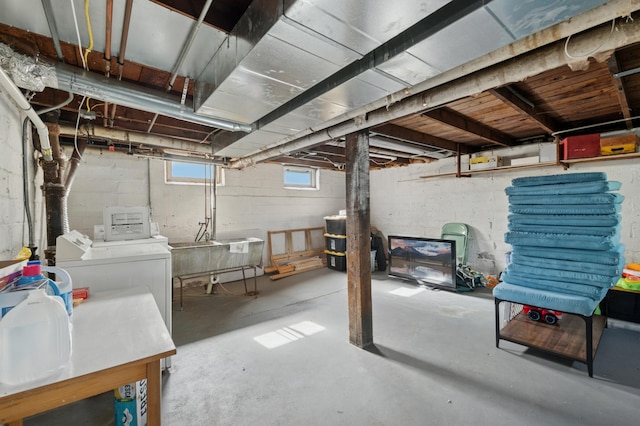 basement featuring a sink and separate washer and dryer