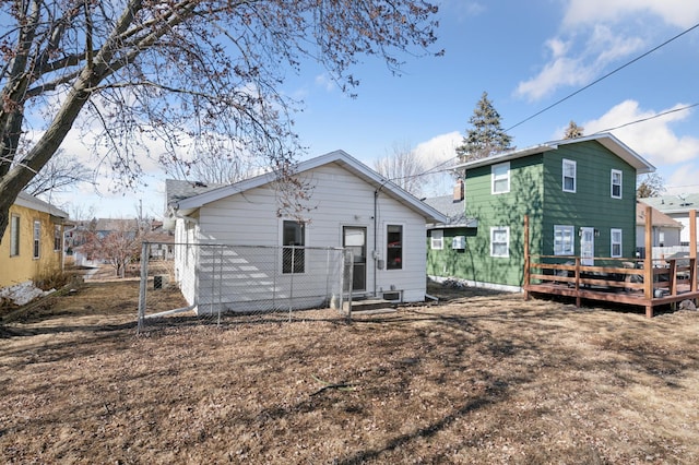 rear view of property with a wooden deck