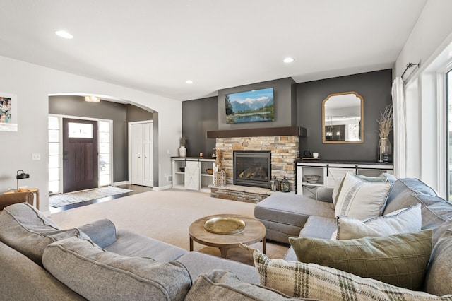 carpeted living area featuring recessed lighting, a fireplace, and baseboards