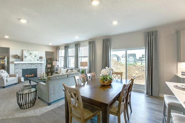 4601 Percheron Blvd, Chaska, MN 55318 - dining area featuring a stone fireplace, recessed lighting, wood finished floors, and a textured ceiling