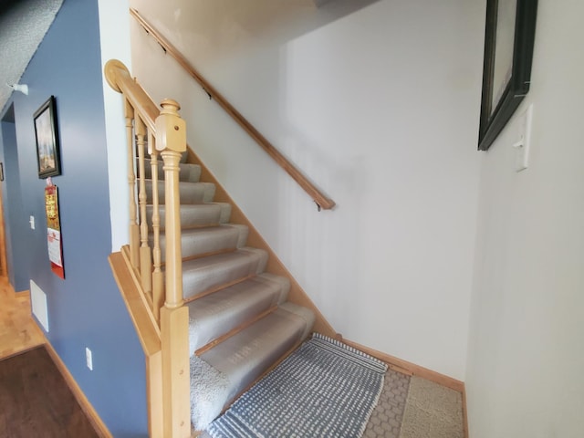 stairs featuring visible vents and baseboards