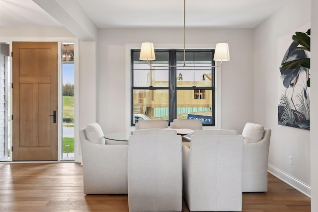 dining area featuring baseboards and wood finished floors