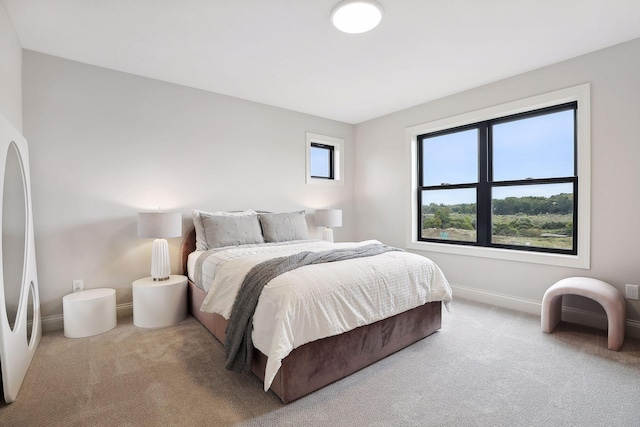 bedroom featuring carpet and baseboards