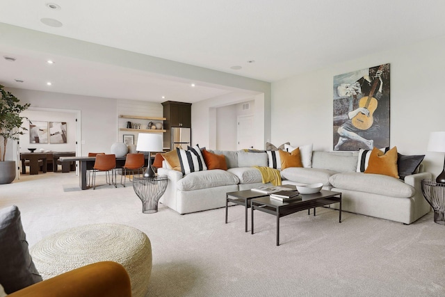 living area featuring recessed lighting and light colored carpet