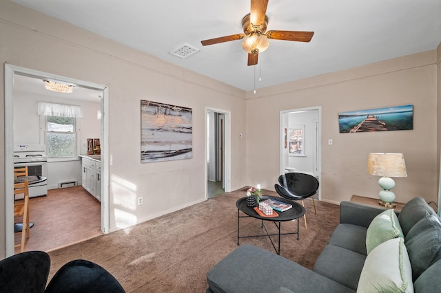 living room with a ceiling fan, a baseboard radiator, light colored carpet, and visible vents