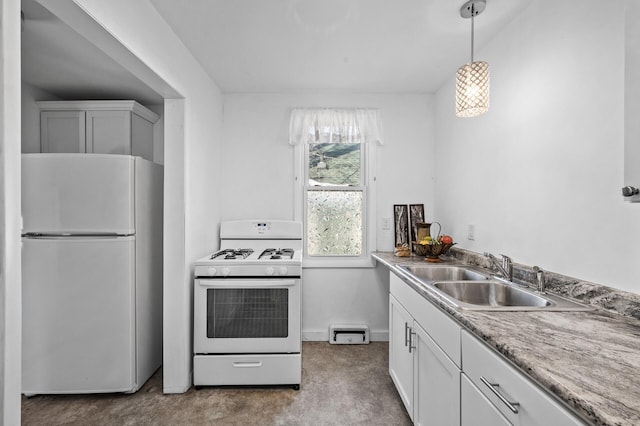 kitchen with light carpet, white appliances, white cabinets, decorative light fixtures, and a sink