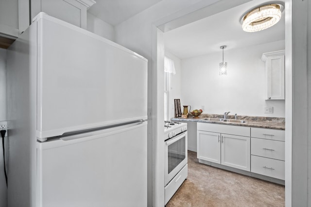 kitchen featuring light carpet, white appliances, white cabinets, decorative light fixtures, and a sink