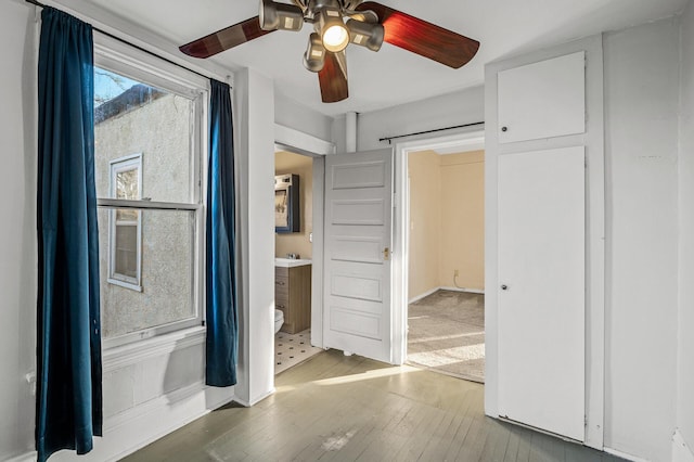 unfurnished bedroom with a ceiling fan and wood finished floors