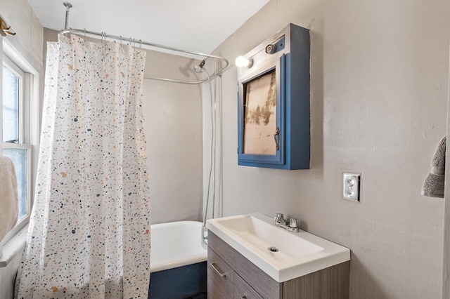 bathroom featuring shower / bath combination with curtain and vanity