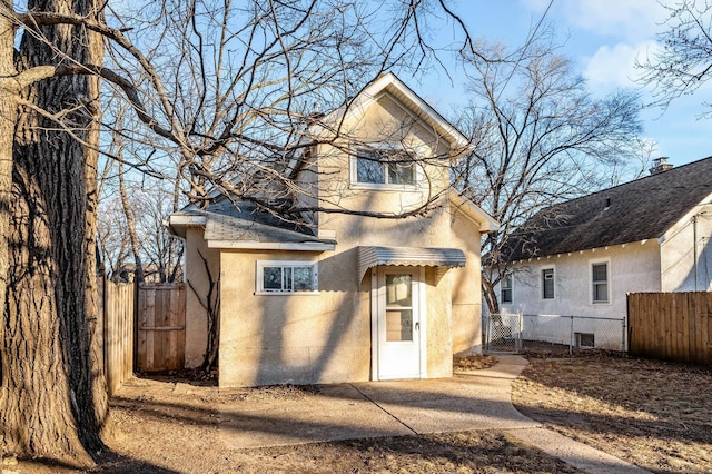 view of front of property featuring fence and stucco siding