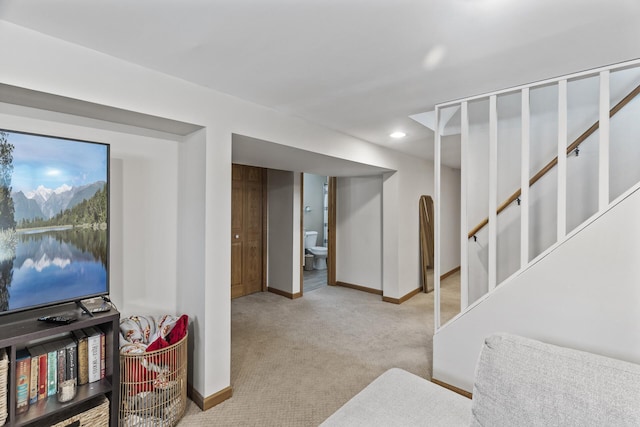 finished basement with recessed lighting, light carpet, baseboards, and stairs