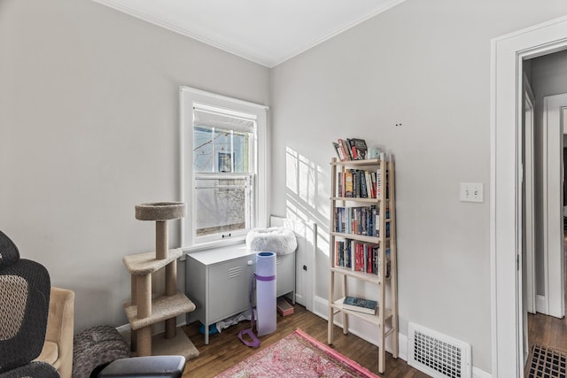 interior space featuring ornamental molding, dark wood-style flooring, visible vents, and baseboards