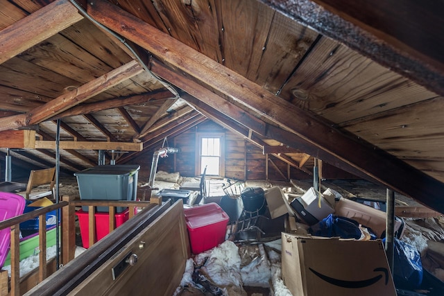 unfinished attic with an upstairs landing