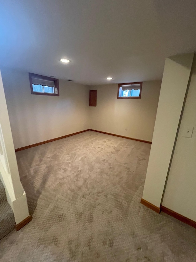 basement featuring carpet floors, baseboards, and recessed lighting