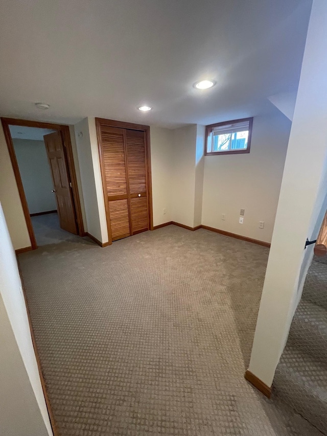 unfurnished bedroom featuring carpet floors, baseboards, and a closet