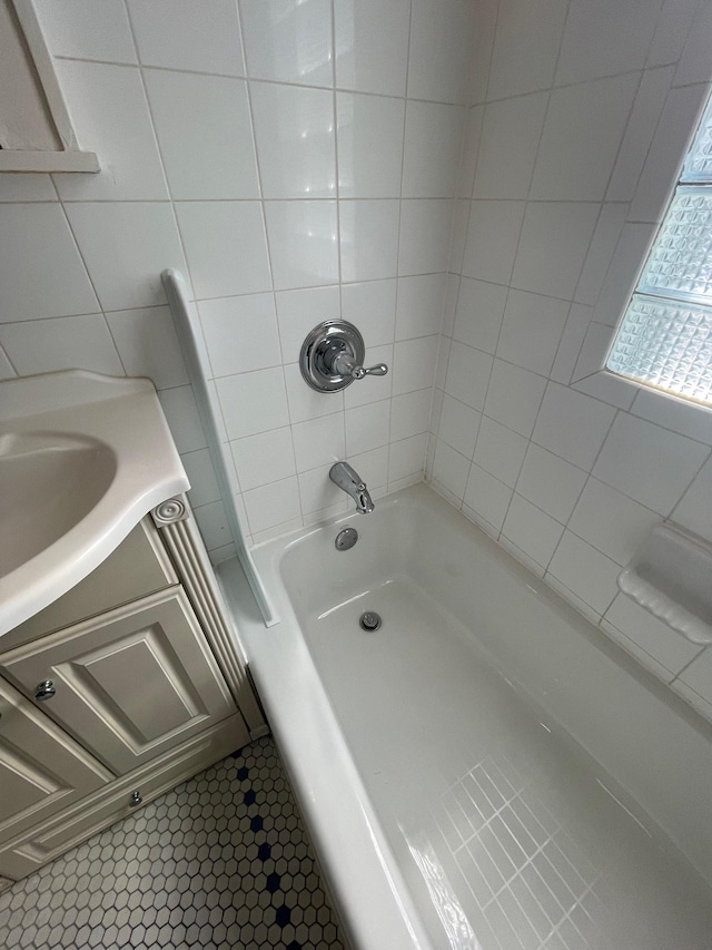 bathroom featuring washtub / shower combination and vanity