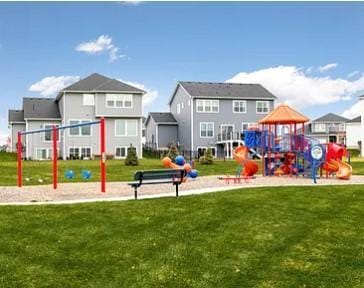 community jungle gym with a residential view and a yard