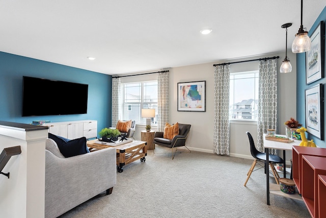 living room with baseboards and light colored carpet