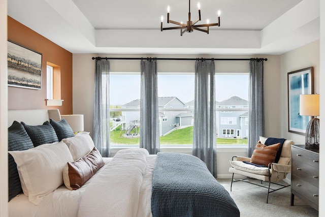 bedroom with carpet and an inviting chandelier