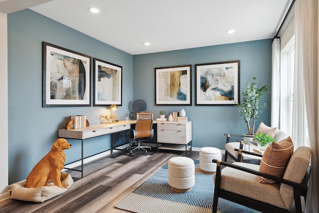 sitting room featuring baseboards, wood finished floors, and recessed lighting