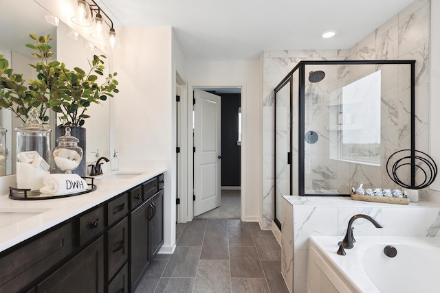 full bathroom with a sink, double vanity, a marble finish shower, and a garden tub