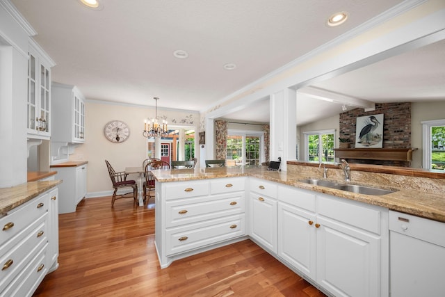 2135 Shadyview Ln N, Plymouth, MN 55447 - kitchen featuring a sink, light wood-style floors, a chandelier, glass insert cabinets, and recessed lighting