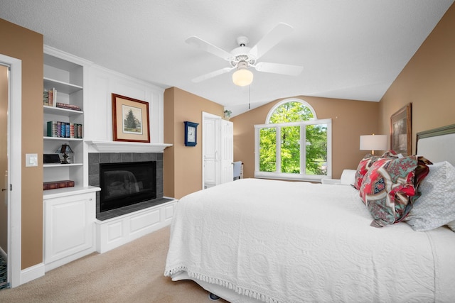 2135 Shadyview Ln N, Plymouth, MN 55447 - carpeted bedroom with a tile fireplace, vaulted ceiling, and a ceiling fan