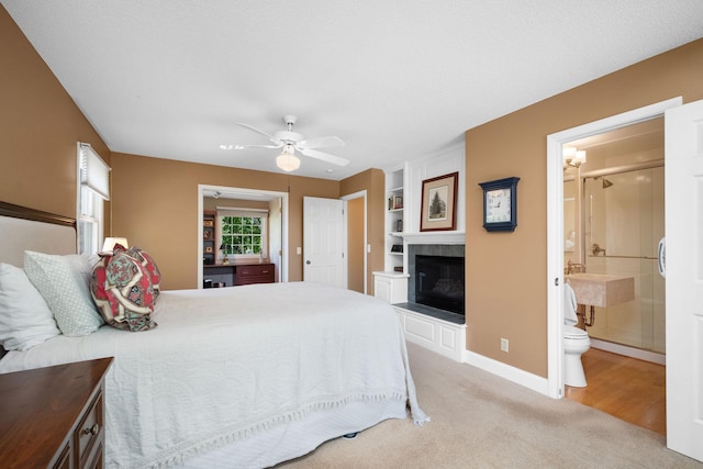2135 Shadyview Ln N, Plymouth, MN 55447 - bedroom with a fireplace, light carpet, baseboards, and connected bathroom