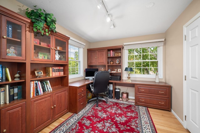 2135 Shadyview Ln N, Plymouth, MN 55447 - office with built in study area, light wood-style floors, rail lighting, and baseboards