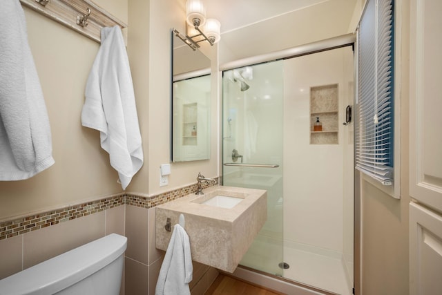 2135 Shadyview Ln N, Plymouth, MN 55447 - full bath featuring toilet, a shower stall, tile walls, wainscoting, and vanity