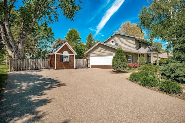 2135 Shadyview Ln N, Plymouth, MN 55447 - view of home's exterior featuring driveway, an attached garage, and a storage unit