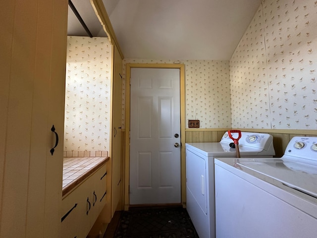 clothes washing area with washer and dryer and wallpapered walls