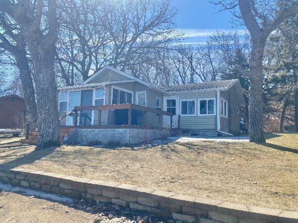 view of front of house featuring a front yard and a sunroom