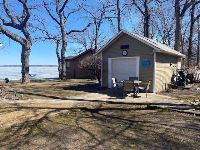 detached garage with a water view