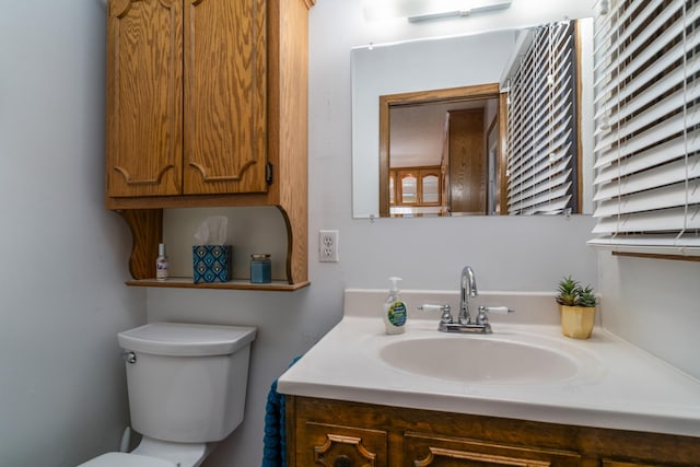 half bathroom with toilet and vanity