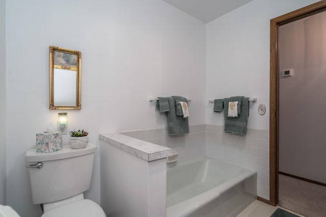 bathroom with a garden tub and toilet