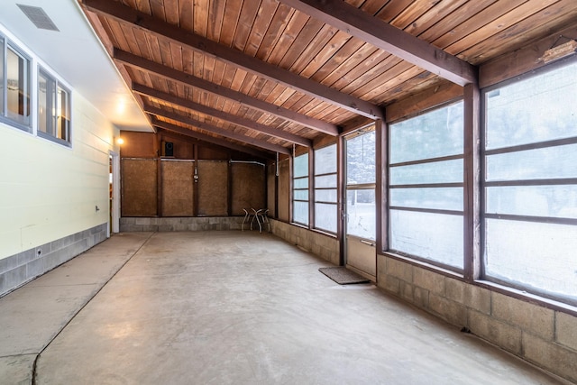 interior space featuring a wealth of natural light, visible vents, and lofted ceiling with beams