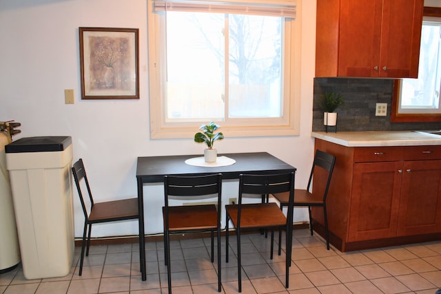 dining area with light tile patterned floors and breakfast area