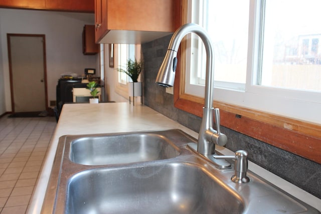 interior details featuring brown cabinets and a sink