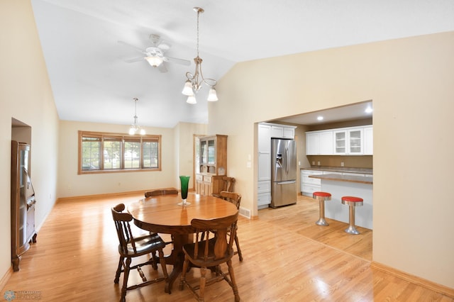 dining area with visible vents, light wood-style flooring, baseboards, and an inviting chandelier