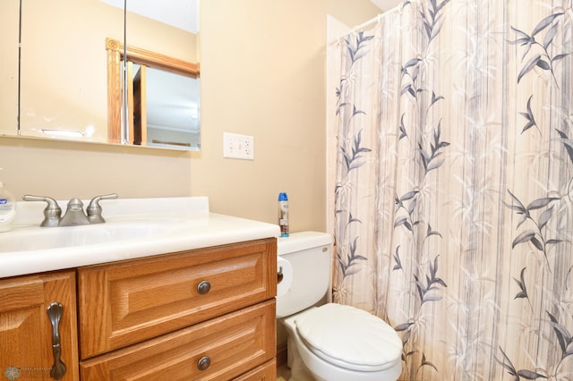 bathroom featuring vanity, toilet, and a shower with curtain