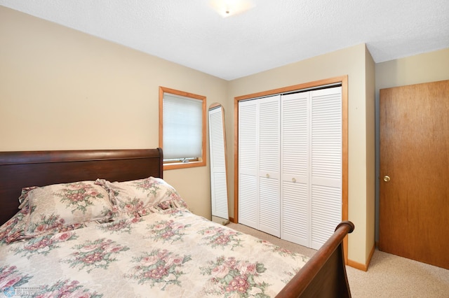 bedroom featuring a closet, carpet, and a textured ceiling