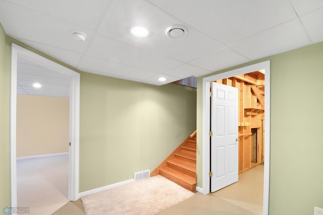 finished basement featuring visible vents, recessed lighting, a paneled ceiling, baseboards, and stairs