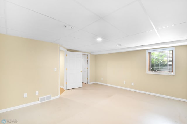 spare room with visible vents, finished concrete flooring, recessed lighting, baseboards, and a paneled ceiling