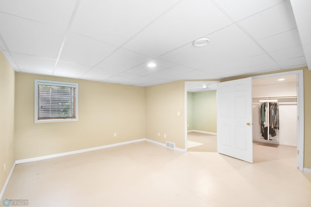 below grade area with recessed lighting, baseboards, visible vents, and a paneled ceiling