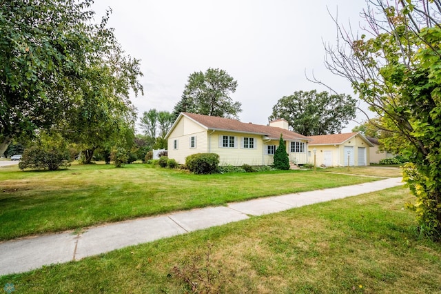 ranch-style home featuring a garage, a chimney, and a front lawn